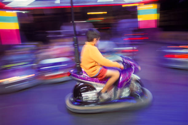 Boy driving a bumper car in an amusement park