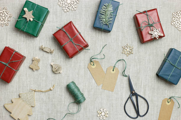 istock Christmas handmade gift boxes on textile background, craft paper wrapped presents with jute string, Christmas or New Year colors gifts. Top view set handcrafted gifts for holidays, eco style 1540503088