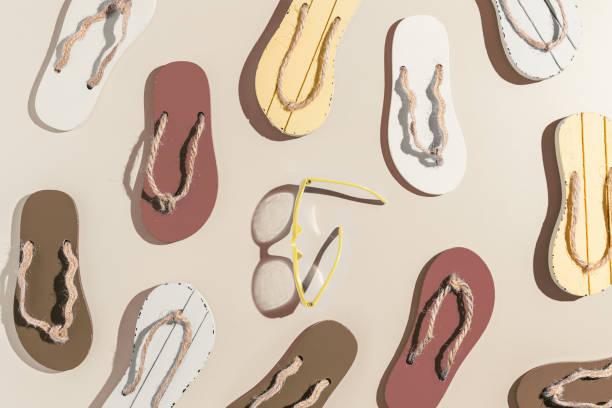 istock Summer flip flops and sunglasses flat lay, creative minimal pattern, beach accessories neutral color, top view still life with female slide sandals, summer beach holiday concept, shadow sunlight 1540503734