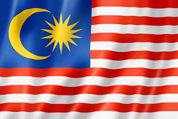 A rippled blue, yellow, red, and white Malaysian flag stock photo