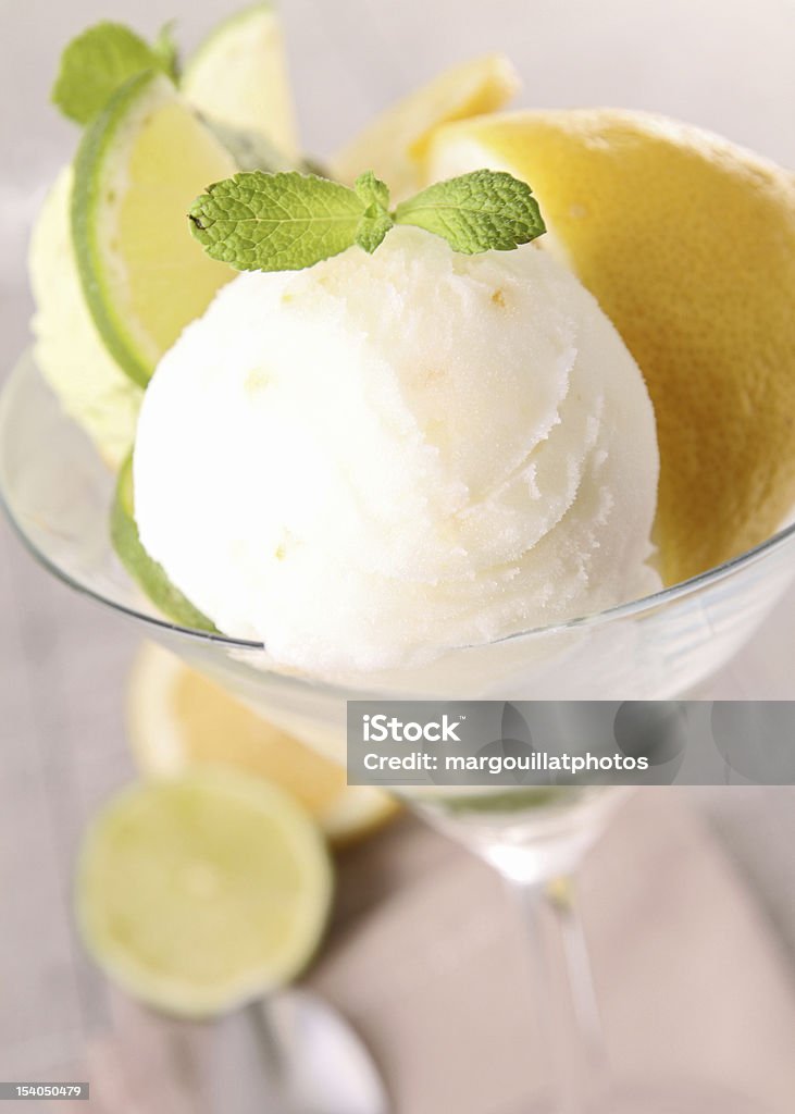 Ice cream with lemon in martini glass with lemons below ice cream Lemon Ice Cream Stock Photo