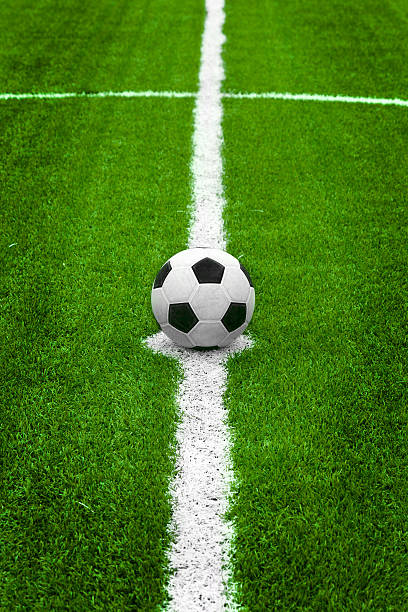 soccer ball on start point center of field stock photo