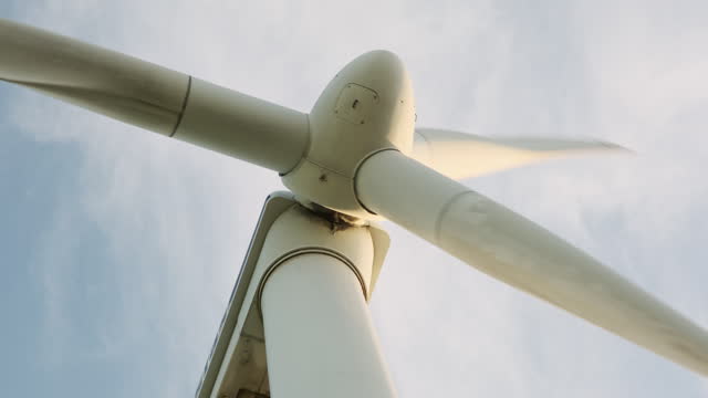 Closeup of the head of a wind turbine with weathered blades