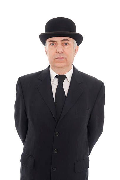 Mature man in a black suit, tie, and top hat English city gentleman isolated on white bowler hat stock pictures, royalty-free photos & images