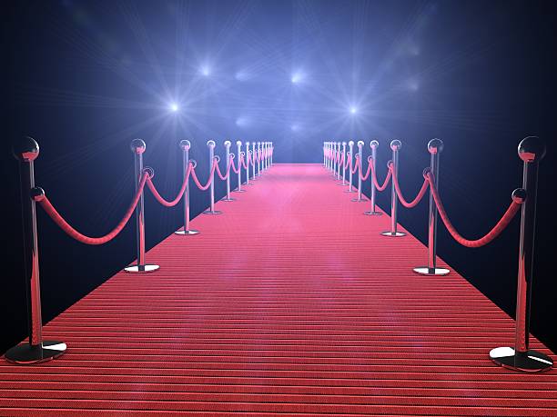 Illuminated red carpet with flashing lights and black walls stock photo