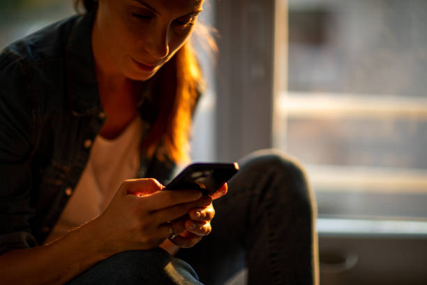 istock A woman sitting at her room window on at sunset 1540561008