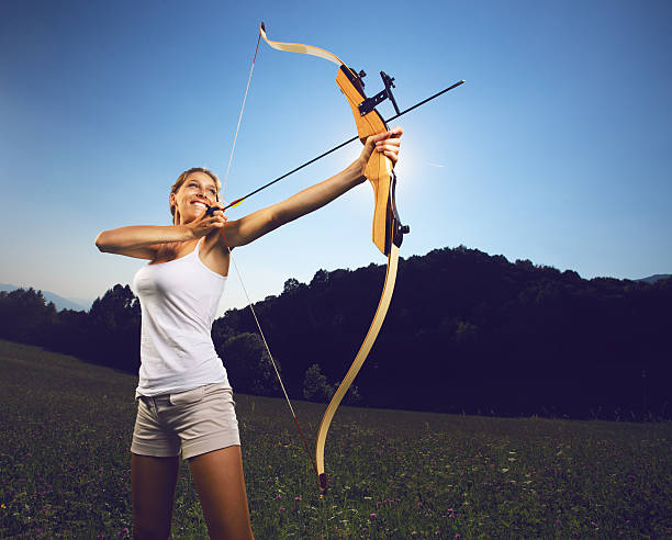 istock Woman archer holding a bow and arrow 154056404