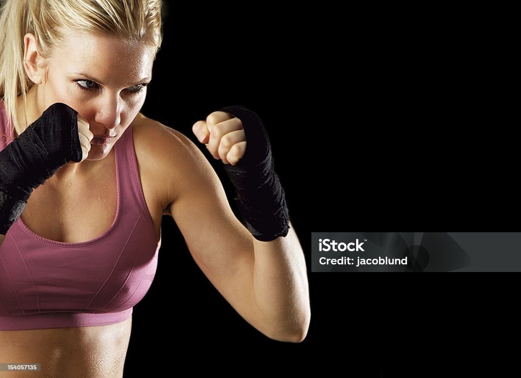 Ready to Fight Portrait of a sexy fitness woman ready to fight. Isolated on black with copy space. 20-29 Years Stock Photo