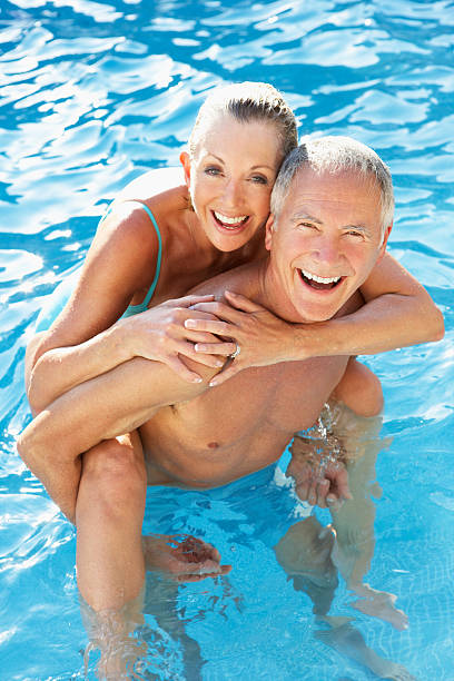 istock Mature couple having fun in the pool 154057326
