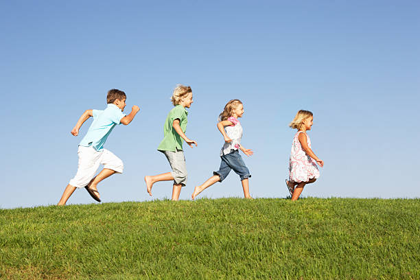 istock Young children running through field 154057782