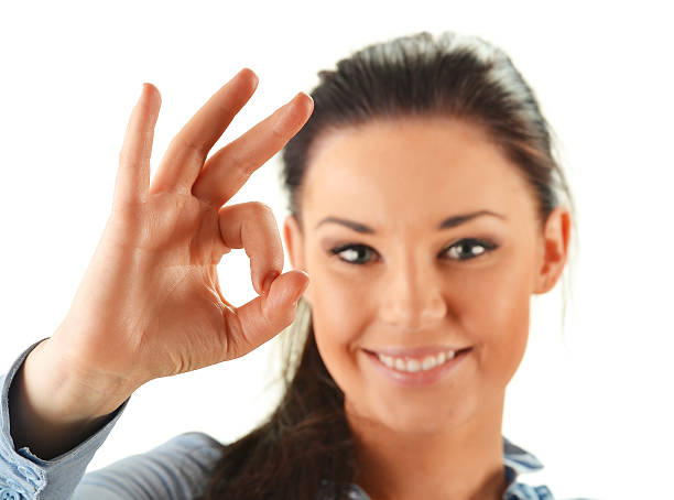 istock Young attractive woman showing ok isolated on white 154059517