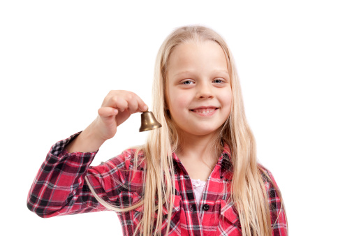 girl holding a small bell on a white background