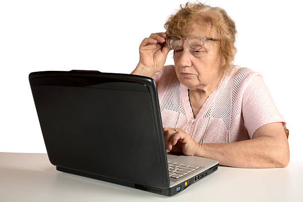 istock Granny with the laptop isolated on a white 154059962