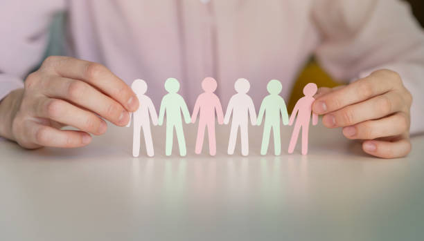istock Holding paper human figures on light blue background, closeup with space for text. Diversity and inclusion concept 1540616698