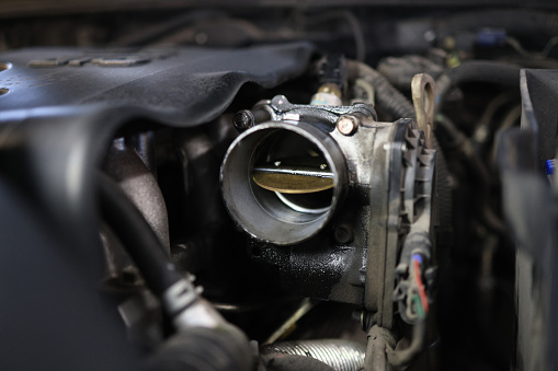 Close up dirty carburetor part of an engine that needs to get maintenance, car service, Gasoline engine.