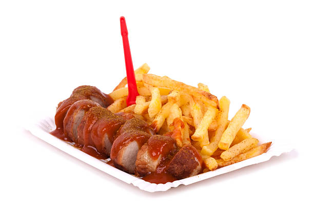 Currywurst with fries on white plate stock photo