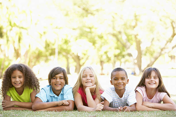 istock Children Lying On Stomachs In Park 154063292