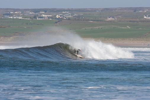 Surfing the Waves off Lahinch beach, Ireland, person not recognizable
