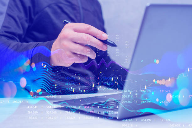 istock Businessman with laptop analyzes financial market data. Futuristic technology solution for business development. Abstract technological background in vibrant colors with blur. 1540649032