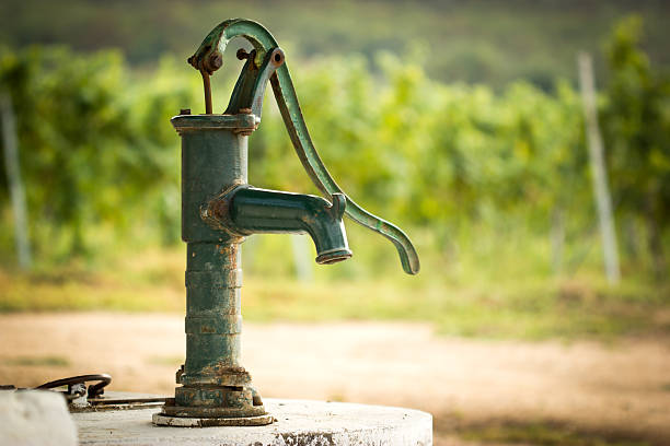 A Green Water Pump in the Countryside in Switzerland, Europe