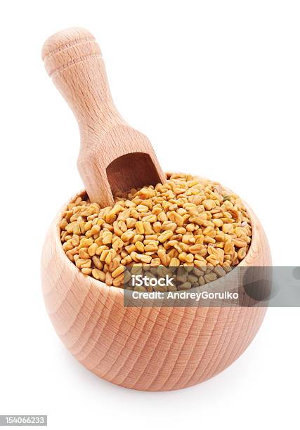 Wooden Scoop In Bowl Full Of Fenugreek Isolated On White Stock Photo - Download Image Now