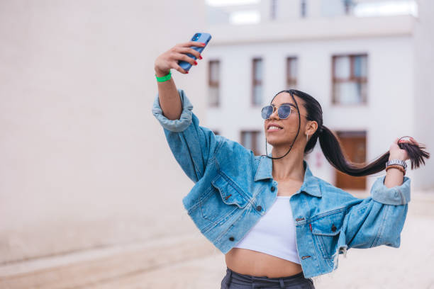 istock Beautiful young woman using phone outdoors 1540677103