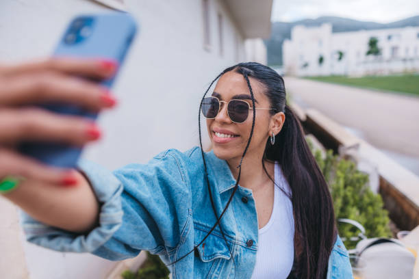 istock Beautiful young woman using phone outdoors 1540678229