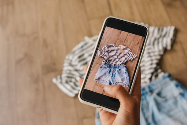 Woman taking picture of used clothes. Selling used clothes concept. Woman taking picture of used clothes. Selling used clothes concept. 2nd base stock pictures, royalty-free photos & images