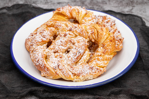 Handcrafted Sweet Brezel on plate. Pastry for a Delicious Snack