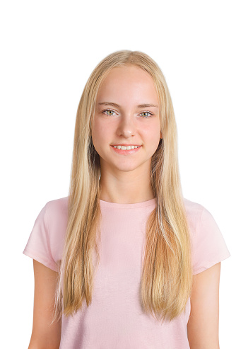 Studio Portrait of a young girl with blue eyes and blond hair. With a little smile..