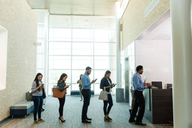 istock Diverse customers wait patiently to see bank teller 1540766451