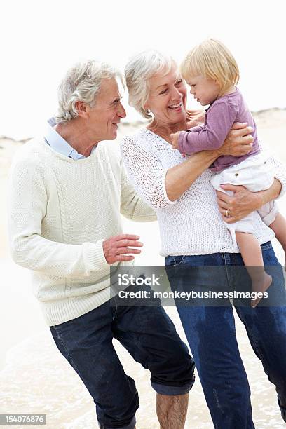 Großeltern Mit Enkelin Zusammen Zu Fuß Am Strand Stockfoto und mehr Bilder von Großeltern - Großeltern, Enkelkind, Gehen