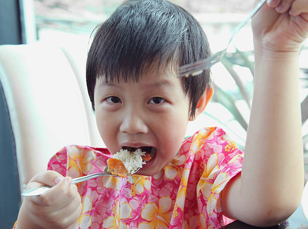 istock Happy young boy eating rice. 154078246
