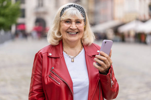 istock Senior woman use smartphone typing text messages browsing internet finishing work looking at camera 1540787943