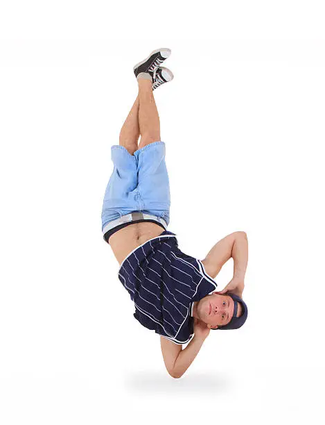 young male dancer performing a bboying stunt