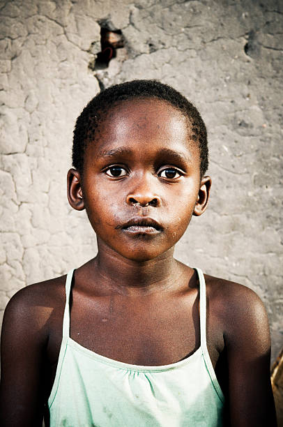 istock Young Xhosa girl infront of mud wall 154079295