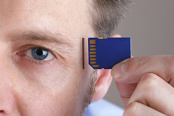 Memory and brain upgrade Inserting SD memory card into slot in human head concept for memory upgrage, forgetfulness or computing memories stock pictures, royalty-free photos & images