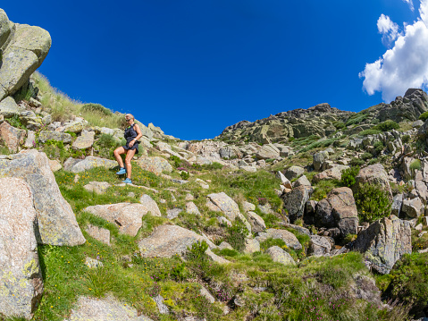 Hiking girl, doing sport, in the mountains