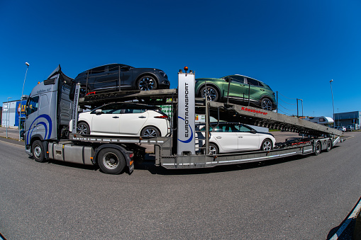 Gothenburg, Sweden - May 05 2023: Large truck loaded with new cars ready for delivery.