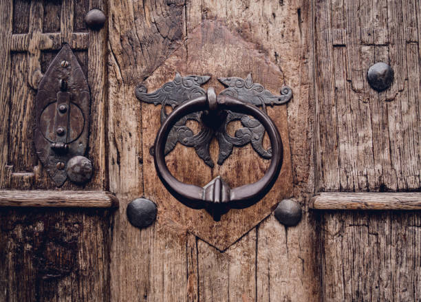 istock A wooden door with beautiful bronze handle knocker. 1540823278