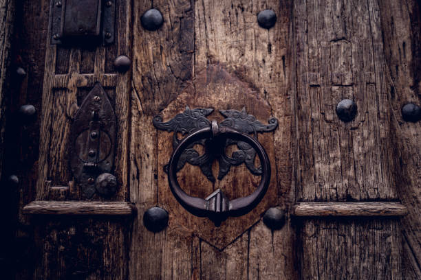 istock A wooden door with beautiful bronze handle knocker. 1540824856