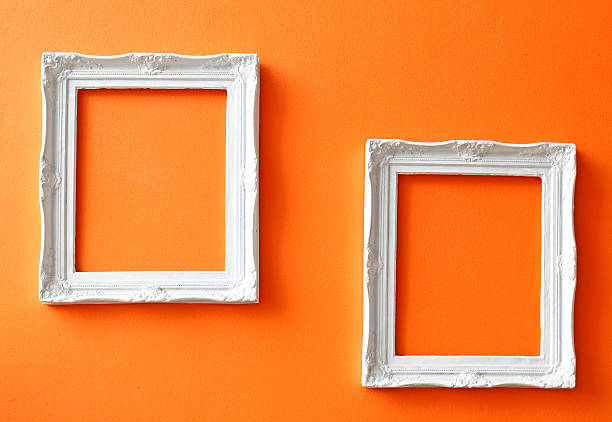 Cтоковое фото white vintage frames on orange стена