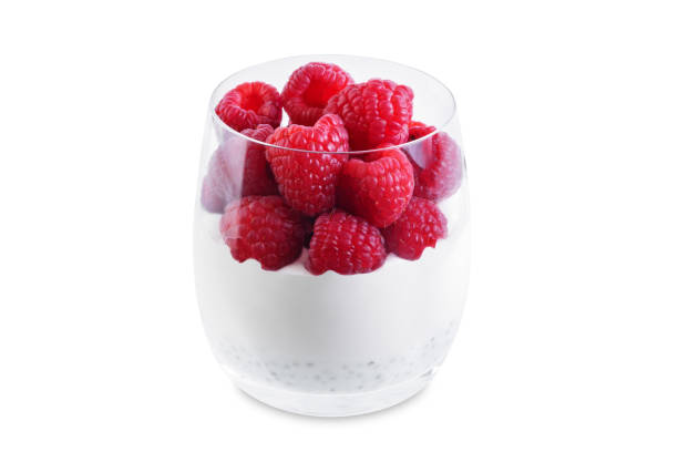 istock Greek yogurt with raspberries in a glass on a white isolated background 1540842809