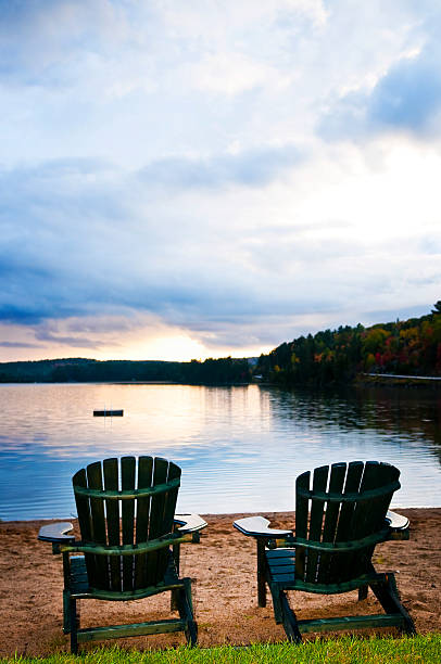 istock Wooden chairs at sunset on beach 154084696