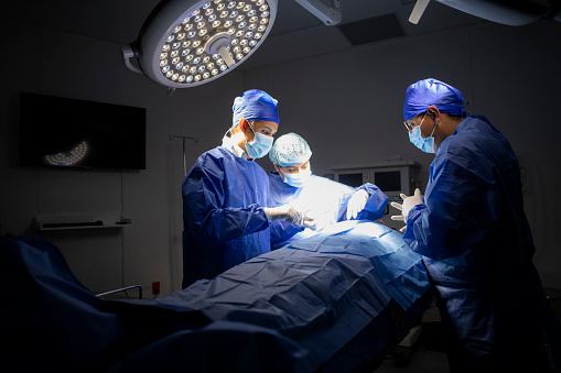 Male and female surgeon working in operation theater of hospital