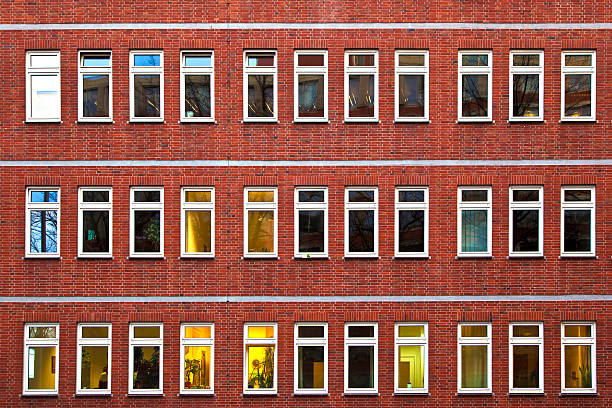 istock facade of office building by night 154086658