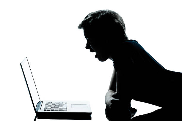 istock one young teenager boy or girl silhouette computer computing lap 154086921