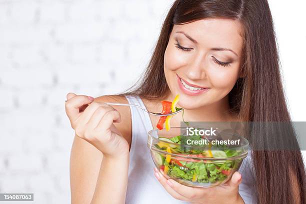 Beautiful Brunette Woman Eating Salad Stock Photo - Download Image Now - Adult, Adults Only, Beautiful People