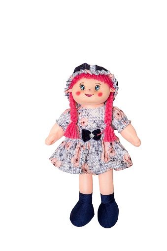 A homemade ragdoll with pink, braided hair and a dress