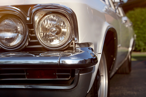 Classic retro white  car. Clouse up headlights.